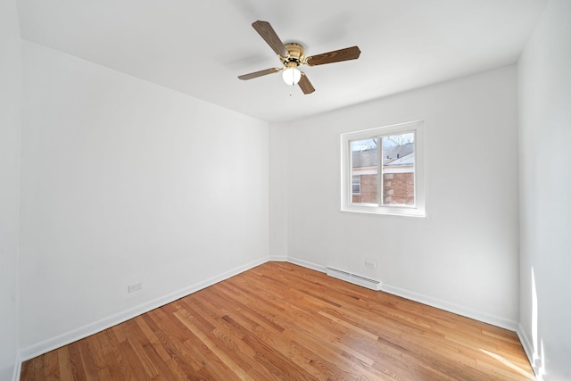 unfurnished room with baseboards, ceiling fan, baseboard heating, and light wood-type flooring