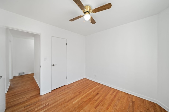 unfurnished bedroom with visible vents, a ceiling fan, baseboards, and light wood-type flooring