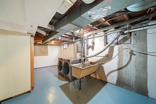 basement featuring independent washer and dryer and a sink