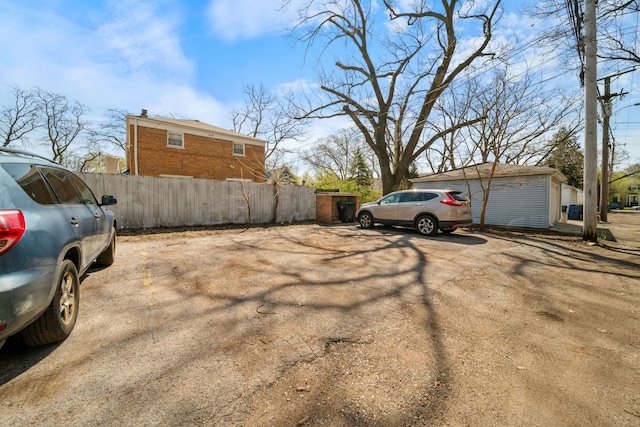 view of parking with fence