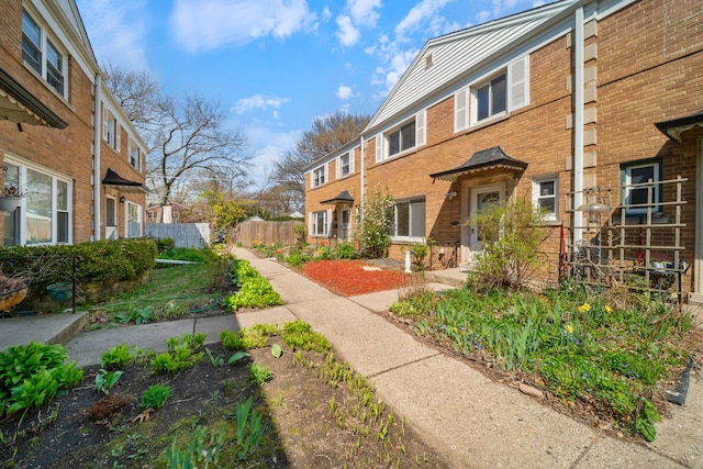 exterior space with fence and brick siding