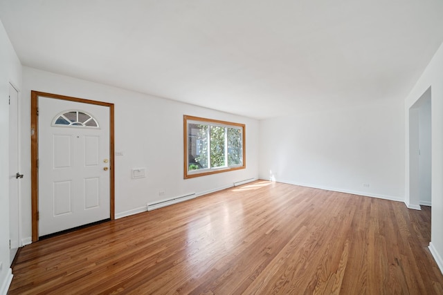 entryway featuring baseboards, a baseboard heating unit, and light wood-style flooring