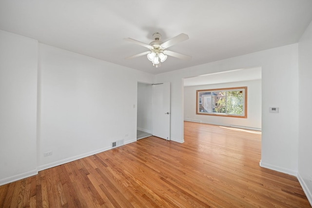 empty room with visible vents, light wood-style flooring, ceiling fan, and baseboards