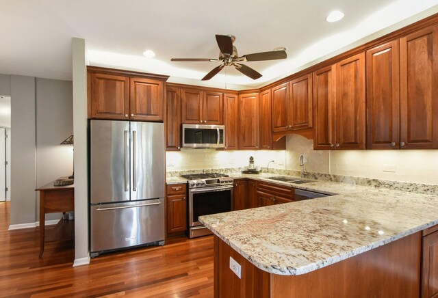 1565 Ashbury Pl, Lemont, IL 60439 - kitchen with ceiling fan, dark wood-style flooring, a sink, a peninsula, and stainless steel appliances