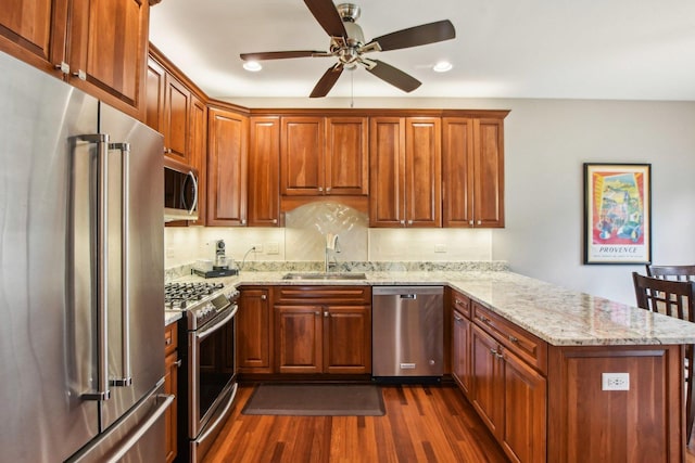 1565 Ashbury Pl, Lemont, IL 60439 - kitchen with a sink, a peninsula, dark wood-style floors, a ceiling fan, and stainless steel appliances