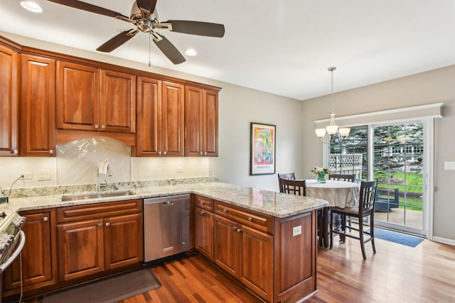 1565 Ashbury Pl, Lemont, IL 60439 - kitchen with appliances with stainless steel finishes, a sink, ceiling fan with notable chandelier, a peninsula, and dark wood-style floors