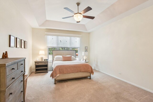 1565 Ashbury Pl, Lemont, IL 60439 - bedroom featuring baseboards, a ceiling fan, a raised ceiling, and light carpet