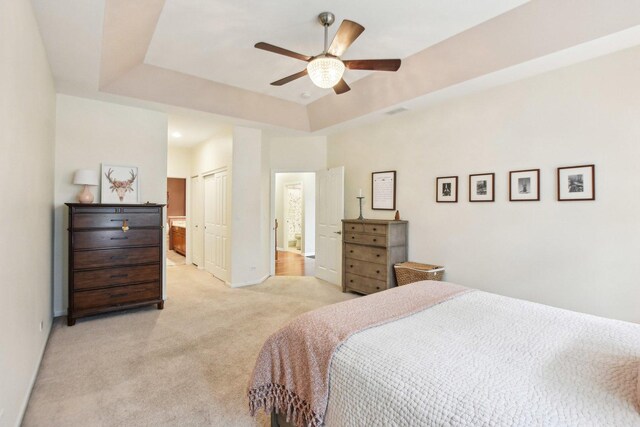 1565 Ashbury Pl, Lemont, IL 60439 - bedroom with a ceiling fan, baseboards, a closet, light carpet, and a tray ceiling