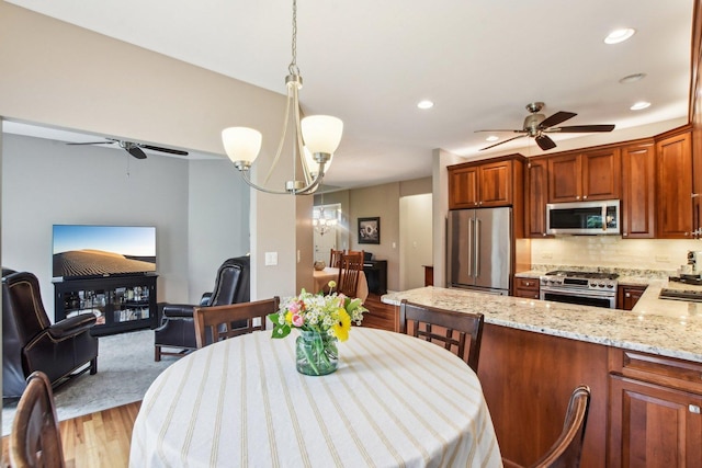 1565 Ashbury Pl, Lemont, IL 60439 - dining space with light wood-style floors, recessed lighting, and ceiling fan with notable chandelier