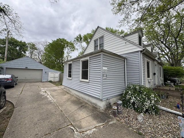 view of side of home featuring an outdoor structure and a garage