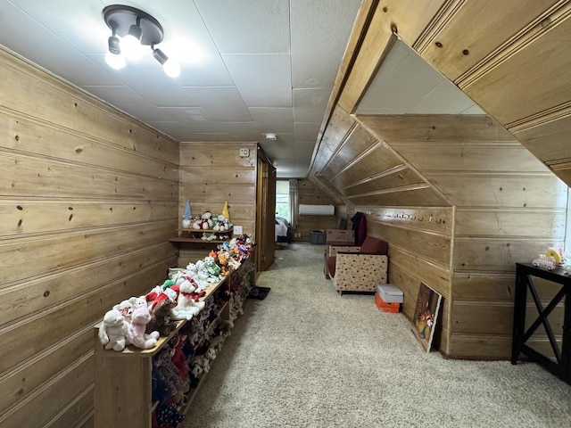 bonus room with wood walls, lofted ceiling, and carpet
