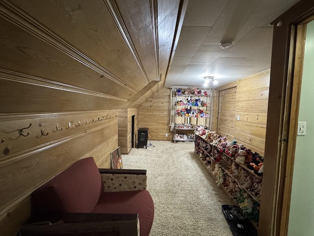 bonus room with carpet floors and wooden walls