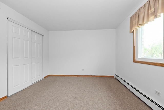 11123 S 84th Ave Unit 2B, Palos Hills, IL 60465 - unfurnished bedroom featuring a closet, baseboards, baseboard heating, and carpet flooring