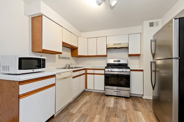 11123 S 84th Ave Unit 2B, Palos Hills, IL 60465 - kitchen with appliances with stainless steel finishes, a sink, light countertops, under cabinet range hood, and visible vents