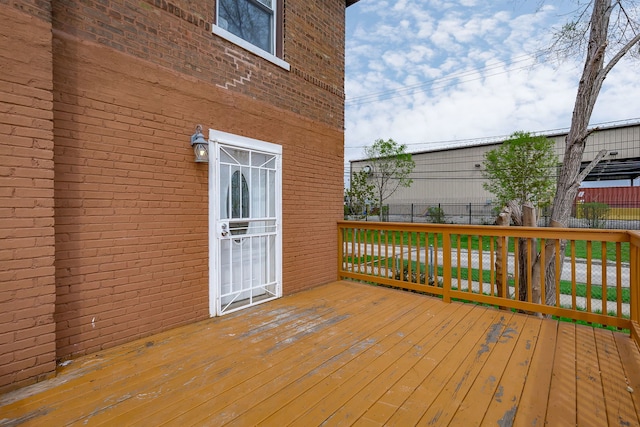 wooden terrace featuring fence