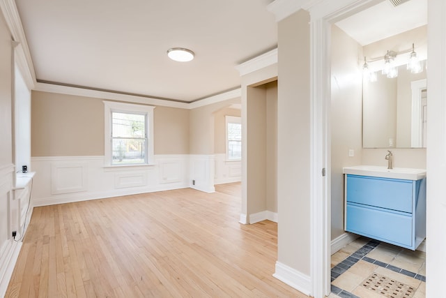 interior space featuring wood-type flooring, wainscoting, visible vents, and vanity