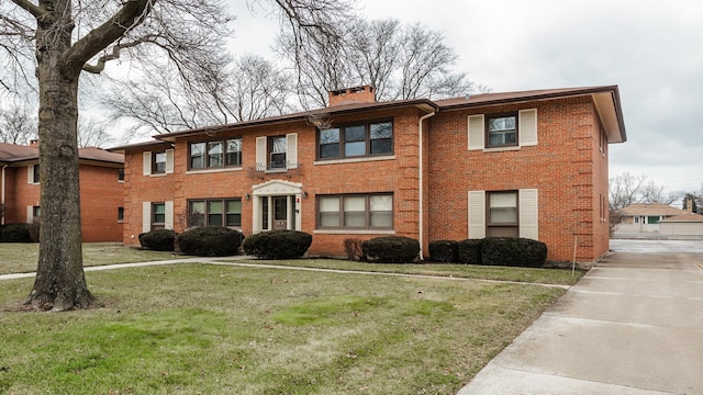 10630 W Cermak Rd Unit 2E, Westchester, IL 60154 - view of front of home featuring brick siding, a chimney, and a front yard