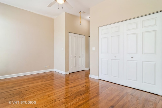 unfurnished bedroom with wood finished floors, baseboards, and ceiling fan