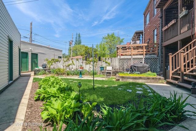 view of yard with fence and stairs
