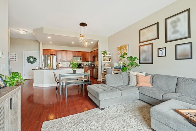 living room featuring recessed lighting and dark wood-type flooring