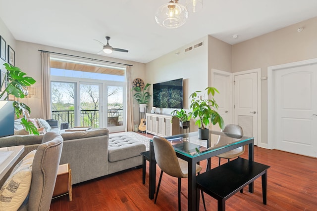living room with ceiling fan, dark wood-style floors, and visible vents