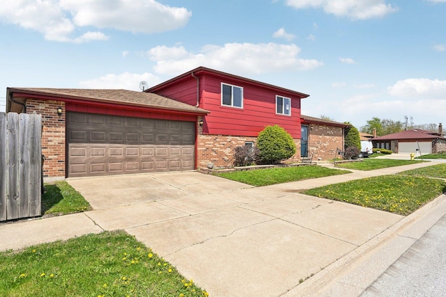 310 Muskegon Ave, Calumet City, IL 60409 - split level home featuring brick siding, an attached garage, and concrete driveway
