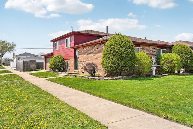 310 Muskegon Ave, Calumet City, IL 60409 - view of property exterior featuring brick siding, a garage, fence, and a yard