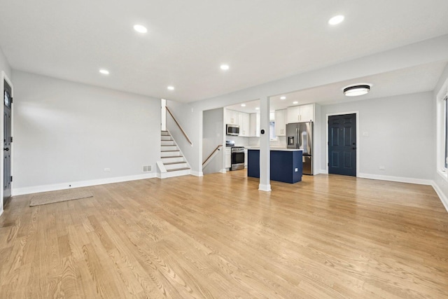 310 Muskegon Ave, Calumet City, IL 60409 - unfurnished living room featuring stairway, baseboards, recessed lighting, and light wood-style flooring