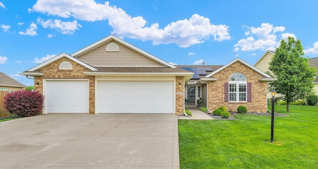 4022 Orchard Ln, Monticello, IL 61856 - ranch-style home with brick siding, concrete driveway, a garage, and roof mounted solar panels