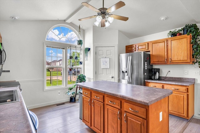 4022 Orchard Ln, Monticello, IL 61856 - kitchen with stainless steel refrigerator with ice dispenser, ceiling fan, light wood finished floors, brown cabinets, and a kitchen island