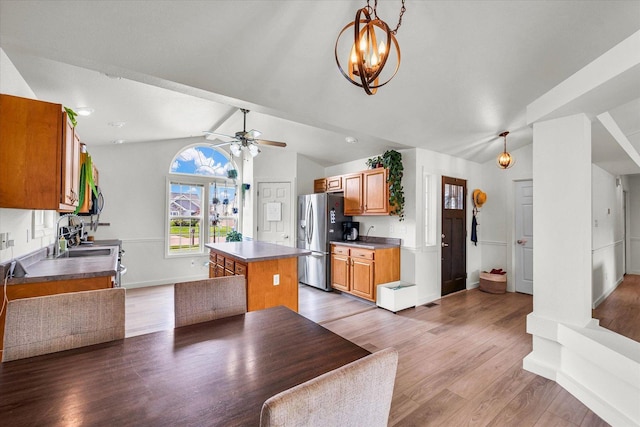4022 Orchard Ln, Monticello, IL 61856 - kitchen featuring stainless steel fridge with ice dispenser, lofted ceiling, light wood-type flooring, a kitchen island, and baseboards