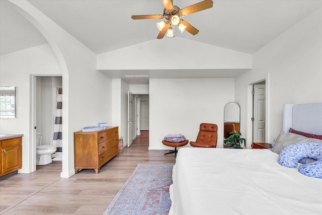 4022 Orchard Ln, Monticello, IL 61856 - bedroom with lofted ceiling, arched walkways, light wood finished floors, baseboards, and connected bathroom