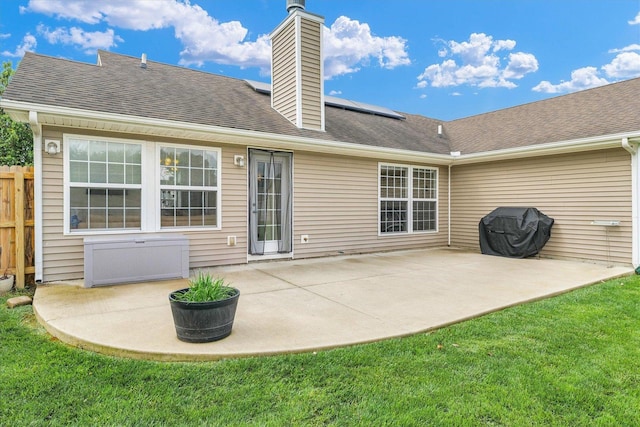 4022 Orchard Ln, Monticello, IL 61856 - rear view of property with roof mounted solar panels, a patio area, a chimney, and a shingled roof
