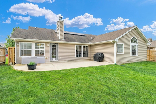 4022 Orchard Ln, Monticello, IL 61856 - back of property with solar panels, a chimney, and a patio area