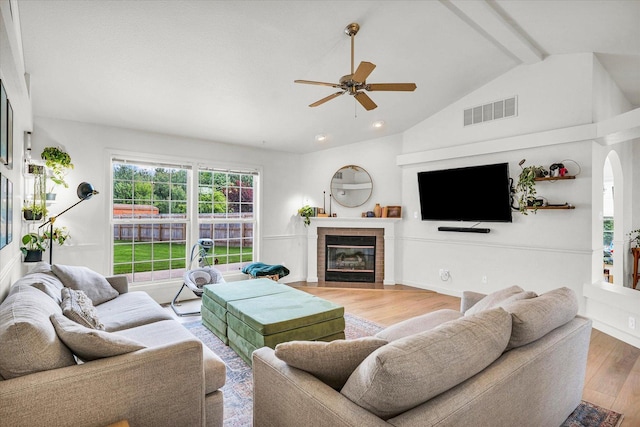 4022 Orchard Ln, Monticello, IL 61856 - living area with a ceiling fan, wood finished floors, a fireplace with flush hearth, arched walkways, and recessed lighting