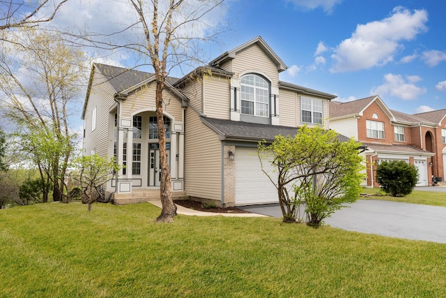 view of front facade with an attached garage, driveway, and a front lawn