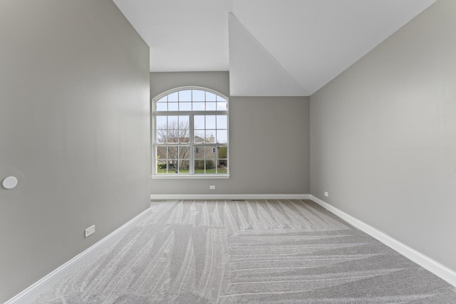 interior space featuring baseboards and vaulted ceiling