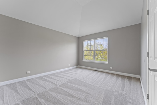 unfurnished room with carpet floors, baseboards, and high vaulted ceiling