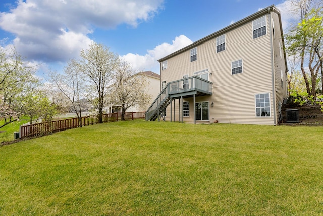 back of property with central AC, fence, a deck, stairs, and a lawn