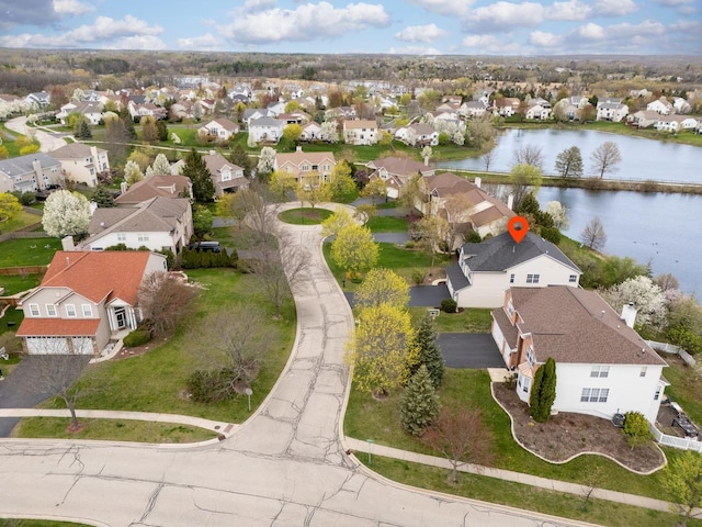 birds eye view of property with a water view and a residential view