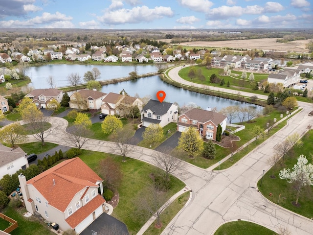 birds eye view of property with a water view and a residential view