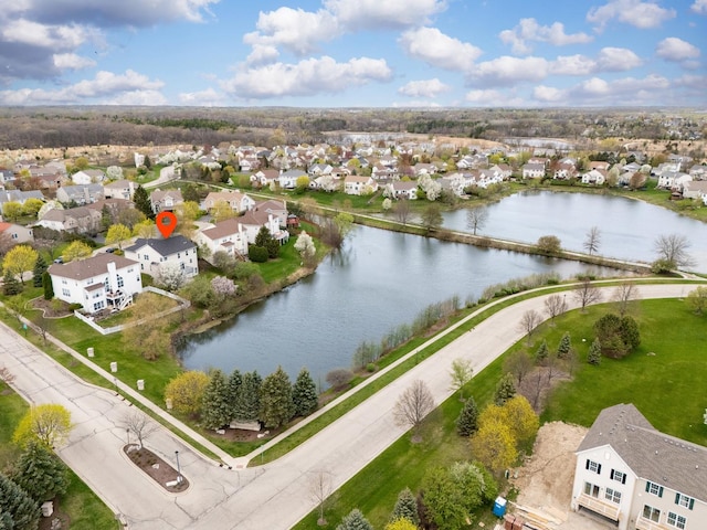 drone / aerial view featuring a residential view and a water view