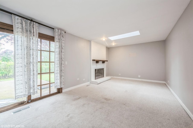 714 New Mexico Trl, Elk Grove Village, IL 60007 - unfurnished living room featuring a skylight, a large fireplace, baseboards, and carpet