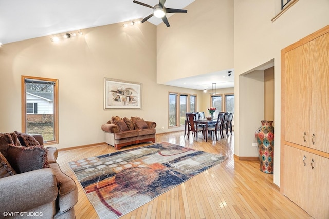 living room featuring plenty of natural light, light wood-style flooring, and ceiling fan