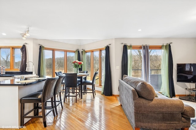 dining area featuring recessed lighting, baseboards, and light wood finished floors