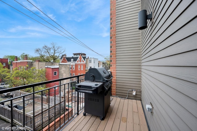 wooden deck featuring a grill