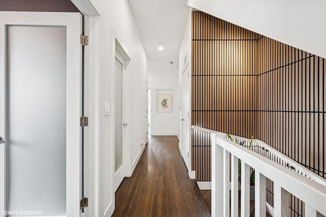corridor featuring wood finished floors, recessed lighting, and baseboards
