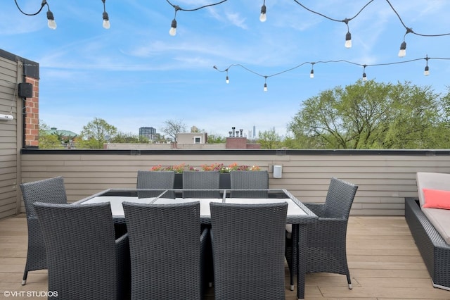 wooden terrace featuring outdoor dining area