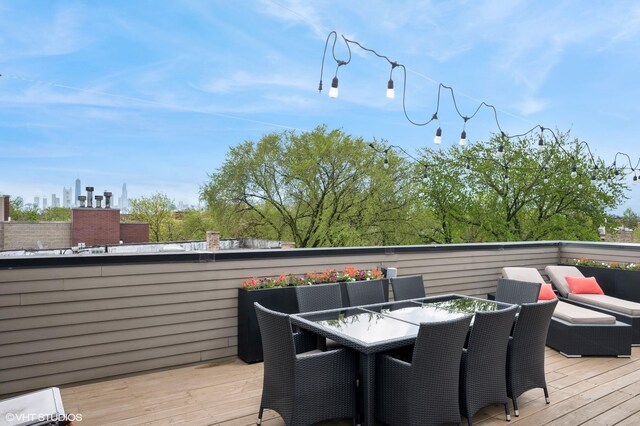 wooden terrace with outdoor dining area