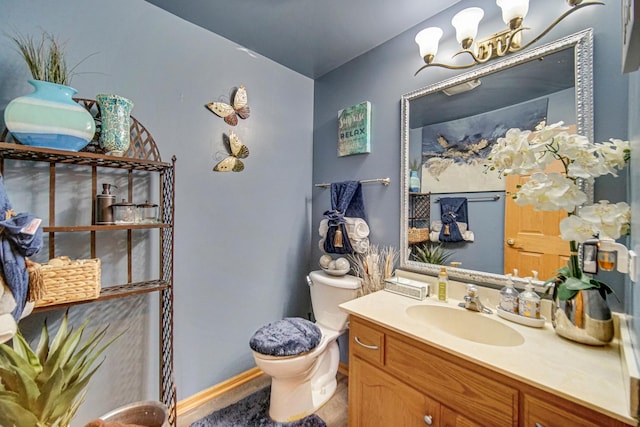 513 Wallace St, Chicago Heights, IL 60411 - half bath with an inviting chandelier, baseboards, toilet, and vanity